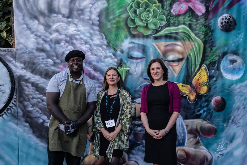 Kenyan graffiti artist Bankslave together with Ms. Constance Nalegach, Head of the International Office at the Ministry of Environment, Chile and Ms. Jane Burston Clean Air Fund's Executive Director in front of a mural related to air pollution during the sixth session of the UN Environment Assembly (UNEA-6) in Nairobi, Kenya on the 28th of February 2024.