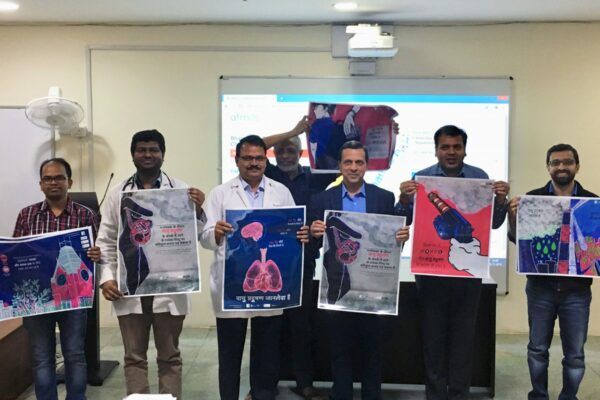 Healthcare professionals hold up posters about air pollution and health.