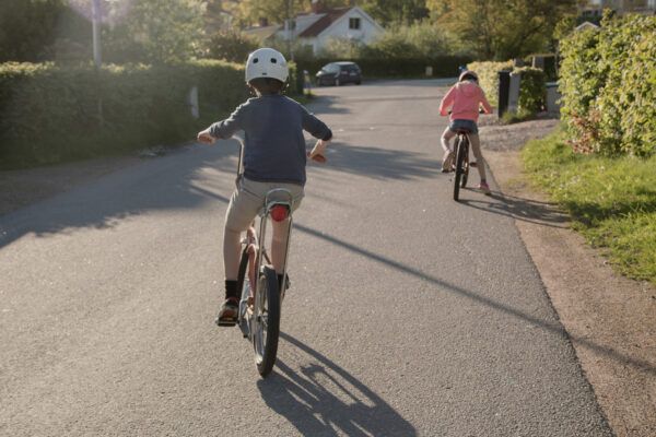 kids cycling on a quiet road