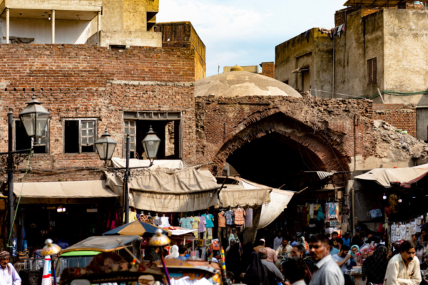 View of the Dehli gate market in Lahore, pakistan. The colourful street of the picturesque market is full of passers by and merchandise.