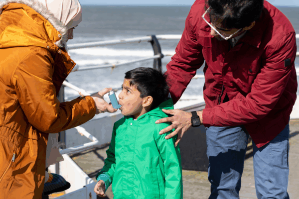 Young boy uses his asthma inhaler on a pier in Saltburn-by-the-Sea, North East England. Credit: iStock