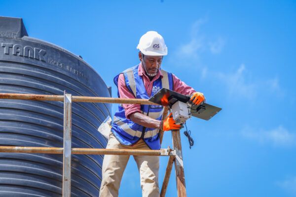An engingeer from Air Quality Systems East Africa installs an air quality sensor in Nairobi, Kenya.