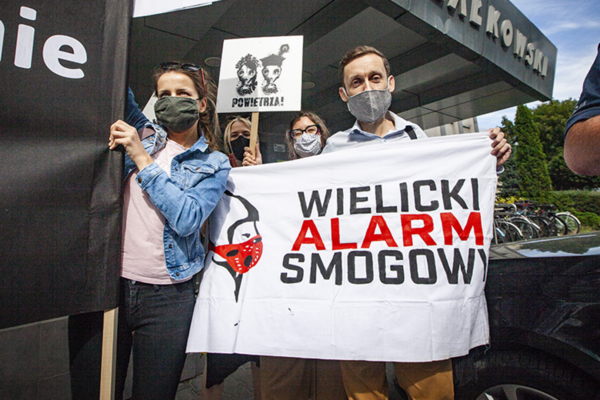 Campaigners holding signs as part of a Polish Smog Alert campaign
