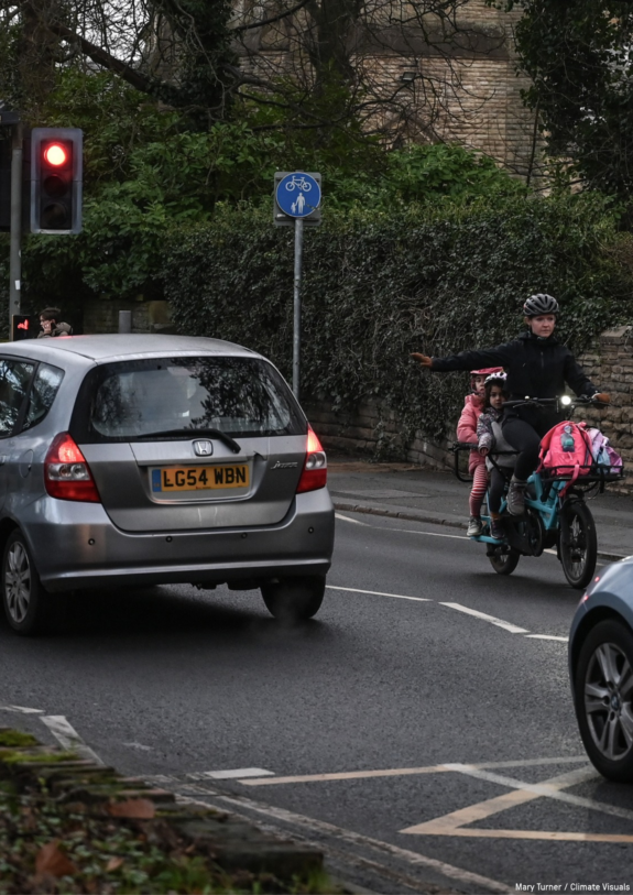 Cyclist passes cars on the street