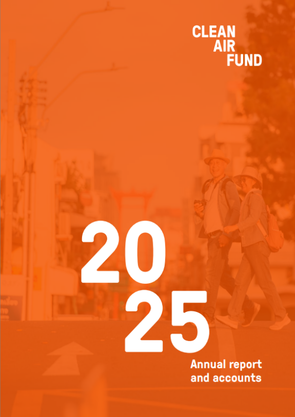 Orange report cover with a happy elderly couple crossing street in the background.