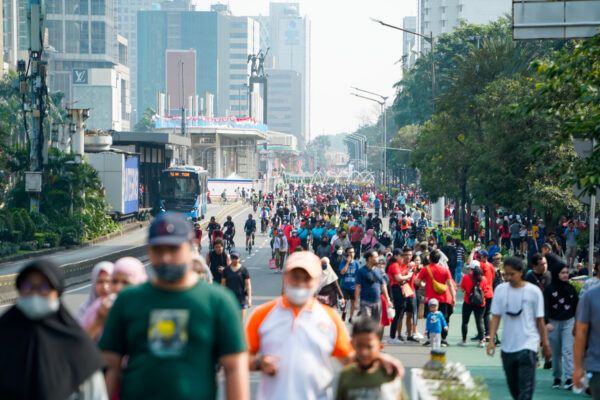 people exercise jogging , walking ,cycling along sudirman road at car free day on sunday morning in jakarta city, indonesia