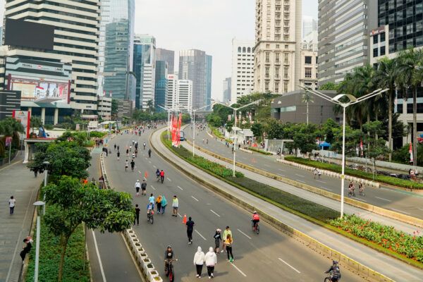 people exercise jogging , walking ,cycling along sudirman road at car free day on sunday morning in jakarta city, indonesia