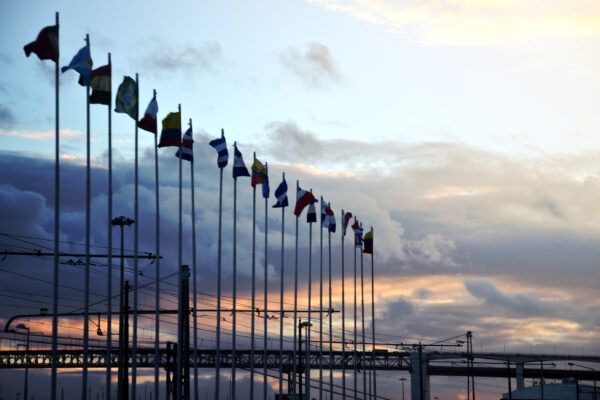 International flags against industrial landscape